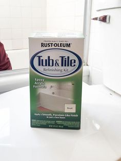 a box of tub and tile sitting on top of a white counter in a bathroom