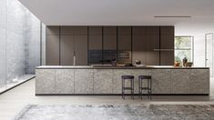 a kitchen with two stools in front of the counter and an area rug on the floor