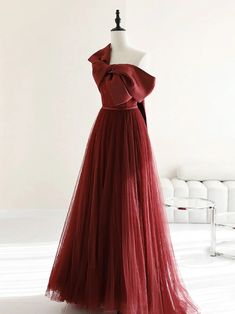 Burgundy Tulle Gown with Dramatic Bow Accent Formal One-shoulder Tulle Evening Dress, One Shoulder Tulle Evening Dress, Formal One-shoulder Tulle Gown, Elegant One-shoulder Tulle Gown, Elegant Off-shoulder Tulle Gown, One-shoulder Tulle Evening Dress, Elegant Evening One-shoulder Tulle Dress, Burgundy Ball Gown For Evening, One Shoulder Evening Dress With Bow For Wedding