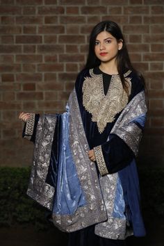 A stunningly marvellous Pheran. This Pheran features intricate Kashmir Tilla embroidery on the neckline and sleeves.- - - - - - - - - - - - - - - - - - - - Product Details- Condition: Brand New (made to order)- Style: Kashmiri Pheran Tunic- Features Pockets on both sides- Fabric: Fine Velvet- Colour: Navy Blue- Embroidery: Tilla Work- Embroidery Colour: Gold- Standard Length: 42" | Can be customized- Care Instructions: Dry Clean Only**If you want the Tunic to be shorter or longer, just send us a Festive Blue Kaftan With Dupatta, Elegant Blue Kaftan With Dupatta, Blue Kaftan With Dupatta For Festivals, Festival Blue Kaftan With Dupatta, Traditional Blue Kaftan With Dupatta, Traditional Drape Kaftan With Intricate Embroidery For Diwali, Traditional Kaftan With Intricate Embroidery For Diwali, Intricate Embroidery Kaftan For Diwali With Traditional Drape, Elegant Blue Salwar Kameez With Embroidered Border