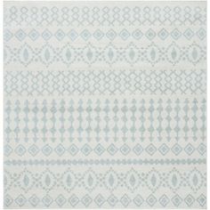 a white and blue rug with geometric designs