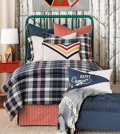 a bedroom with plaid bedding and pillows