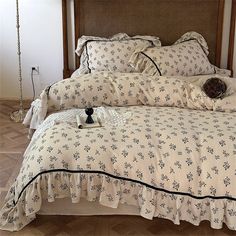 a bed with white and black bedspreads on it