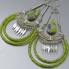 Natural light green serpentine stone earrings with metal-formed alpaca silver metal and tiny beads *Please use the zoom button for a better view of the elaborated design* Our metal formed earrings are lightweight, comfortable to wear and gentle with your earlobes These light green stone beads earrings have a drop length of 3.75 inches, great combination of colors and materials, beautiful serpentine stone beads with interspersed natural minerals that make every piece unique, the dangling metal be Green Bohemian Chandelier Earrings, Green Bohemian Metal Chandelier Earrings, Green Metal Bohemian Chandelier Earrings, Nickel Free Bohemian Jade Earrings, Unique Silver Wire Wrapped Beaded Earrings, Distinctive Silver Wire Wrapped Beaded Earrings, Nickel Free Green Bohemian Chandelier Earrings, Bohemian Nickel Free Jade Earrings, Green Bohemian Chandelier Earrings Nickel Free