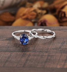 "MADE TO ORDER * Material: Solid gold(14K/18K white/yellow/rose gold) * DETAILS  Engagement ring - center stone: Lab sapphire 6*8mm oval cut - width: approximately 1.5mm - thickness: approximately 1.3mm Side stone: Moissanite or Diamond - diamond:0.16ct,2*3mm pear cut, Color G-H, Clarity SI-VS - moissanite:0.16ct Wedding band Stone: Moissanite or diamond - diamond:0.17ct,Color G-H, Clarity SI-VS - moissanite:0.17ct Width: approximately 2.7mm Thickness: approximately 1.4mm * Click on the \"Pin It\" icon if you like this item * Custom Order We can make custom rings in almost any shape and style. If you want a specific model, please send us a clear picture and we will do our best.  * Shipping Most items take 3-4 weeks to create.I'm happy to rush your order, fees may apply, write me for detail Blue Sapphire Engagement Ring Silver, Non Traditional Unique Engagement Rings Vintage Blue Sapphire, Saphire Engament Ring Set Silver, Intertwined Ring, Sparkly Rings, Sapphire Wedding Ring Set, Sapphire Antique Ring, White Gold Sapphire Ring, Sapphire Engagement Ring Set