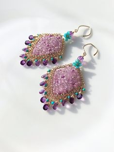 These are some natural pink-purple sapphires, and I weaving them together with gold wire, making this gentle pink-purple even stronger. matched with equally bright amethyst, embellished with some turquoise and blue lampwork flowers. The metal part is 14k gold-filled, which will not fade or cause skin discomfort. 🌸The delivery time to Most regions of North America, Australia and Europe is usually about 10-15 days. Buyers from Brazil, South Korea, and Indonesia, please provide me with your tax number through messages or notes for smooth shipment. Thank you. 🌸Please let me know your phone number when you place an order. It will be used for shipping label only. 🌸I will pack the goods very carefully and beautifully. They can be used as gifts. 🌸Thank you for liking my work. If you have any q Lampwork Flowers, Chandelier Earrings Gold, Gold Chandelier Earrings, Earrings Chandelier, Earring Ideas, Purple Sapphire, Shipping Label, Gold Filled Earrings, Earrings Unique