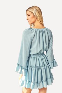 For a casual, stunning look turn to this flared mini dress, crafted with a light woven peasant fabric. Featuring bell sleeves, a tiered ruffled skirt, and an elastic waistline. -V neckline with ties.-Long bell sleeves.-Elastic waistline.-Ruffled, tiered skirt.-Lined.-60% Cotton 40% Poly.-By Mustard Seed USA. Size Guide -The model is wearing a size Small.-Model Specs. HEIGHT 5'9" BUST 32" WAIST 24" HIPS 34" Shipping ﻿-Ships within 5 days in the US. Ruffled Mini Hem Dress For Brunch, Brunch Mini Dress With Ruffle Hem, Flowy Ruffled Skirt Mini Dress For Vacation, Spring Smocked Dress With Ruffle Hem And Sleeves, Feminine Smocked Mini Dress With Ruffle Hem, Flowy Tiered Skirt Mini Dress For Beach, Feminine Smocked Dress With Ruffle Hem And Sleeves, Flowy Tiered Mini Dress For Beach, Elegant Smocked Dress With Ruffle Hem And Sleeves