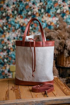 Leather canvas bag made by OKRA workshop is a unique item with very comfortable closure. It is an elegant canvas tote bag for any occassion - evryday bag, shopping bag, beach bag. It is made of very strong waterproof canvas (100% cotton) and cognac brown vintage leather. You can easily change the color of leather, we will make any combination for you. Our bag has a leather shoulder strap for your convenience. Dimensions of the bag: Height - 55 cm/22 inch Width - 30 cm/12 inch Depth - 12 cm/4.7 i Canvas Beach Bag With Handles For Daily Use, Large Capacity Bucket Canvas Bag, Large Canvas Beach Bag For Shopping, Canvas Bucket Bag With Double Handle For Everyday Use, Everyday Canvas Bucket Bag With Double Handle, Everyday Beach Bag With Leather Handles And Canvas Material, White Bucket Bag With Canvas Lining, Canvas Tote Beach Bag For Everyday Use, Everyday Canvas Beach Bag With Leather Handles