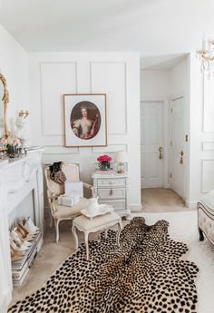 a bedroom with white walls and leopard print rug