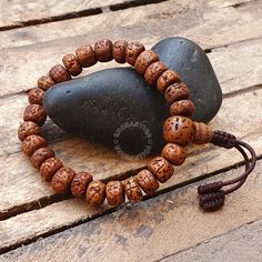 Introducing our exquisite Natural Aged Brown 5 Mukhi Rudraksha Buddhist Bracelet, a harmonious fusion of spiritual significance and timeless elegance. Handcrafted with care, each Rudraksha bead is meticulously sanded in a tumbler, ensuring unparalleled comfort against your skin. The beads are then naturally stained and delicately oiled, revealing a stunning and rich brown hue that accentuates the inherent beauty of these sacred seeds. Our artisans skillfully incorporate an adjustable knot into the design, allowing you to personalize the fit for optimal comfort. The bracelet not only serves as a meaningful accessory but also carries the essence of tradition and mindfulness. 📏Beads Size : 8-8.5 MM  📏Bracelet length: 7.0-7.25 Inches - Adjustable to 2.0 inches The 5 Mukhi Rudraksha beads hol