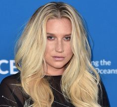 a blonde woman with long hair and black dress