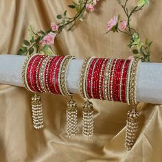 Stunning and unique set of red bangles with pearl kaleereh detailing, comes as a pair for both arms.  With antique gold bangles and champagne zircon crystals. Hot pink metal bangles and beautiful long Kaleereh jhumka bangles! Perfect for your special day  Very limited stock!  Ready to ship 📦 Cheap Red Festive Bangle, Luxury Handmade Bangle For Festive Occasions, Festive Celebration Bangle, Red Hand Set Bangle For Festivals, Hand Set Red Bangle For Festivals, Red Bollywood Bracelets For Wedding, Elegant Red Tilla Bangle, Red Bollywood Bracelets For Celebration, Red Bollywood Bangle For Party