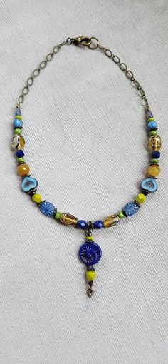 I used a mix of glass beads -some are antique - and semiprecious calcite beads to create this colorful and one of a kind necklace. The variety of shapes, the blues, greens and yellows of the beads create an eye catching harmony. Length of necklace: 18,5 inches. Focal: 2 inches Bohemian Czech Glass Round Beads, Bohemian Turquoise Glass Necklaces, Bohemian Czech Glass Gemstone Beads, Multicolor Czech Glass Necklace One Of A Kind, Bohemian Blue Czech Glass Necklaces, Bohemian Czech Glass Pendant Beaded Necklace, Handmade Bohemian Glass Crystal Necklaces, Bohemian Turquoise Glass Necklace, Handmade Glass Crystal Necklace In Bohemian Style