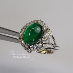 This Antique Platinum Diamond Ring has a strong deep green emerald cabochon with internal glow. The diamonds are transition cut, which dates it back between 1920s and 1940s. Ring Size: 7 Total Weight: 7.15 grams Face Sie: 0.8 inch x 0.7 inch Precious Metal: Platinum Precious stones: -Emerald Center Stone: 5.58 carats, 13.7mm x 10.7mm -White Round Diamonds: 2.05 carats 1940s Ring, Platinum Diamond Ring, Emerald Cabochon, Estate Ring, Estate Rings, Platinum Diamond Rings, Brooch Bouquets, Platinum Ring, Green Emerald