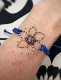 This cute hand shaped flower is is embellished with a beautiful Fluorite stone.  The Copper has been antiqued (oxidized and blackened) then polished for a more rustic look. Copper will naturally darken over time but a jewelry polishing cloth can help to bring back some of its shine.  The bracelet is adjustable and made with lightly waxed polyester cord making it water resistant. This beautiful piece of jewelry would be perfect for you or a gift for that special someone! **Please note that copper Bohemian Bracelets With Flower Charm For Jewelry Making, Spiritual Flower-shaped Bracelets As Gifts, Spiritual Flower-shaped Bracelets For Gift, Spiritual Flower Bracelets For Gifts, Adjustable Hippie Flower Jewelry, Unique Adjustable Flower Jewelry, Unique Adjustable Flower-shaped Jewelry, Adjustable Wire Wrapped Braided Bracelet As Gift, Bohemian Flower Bracelets Nickel Free