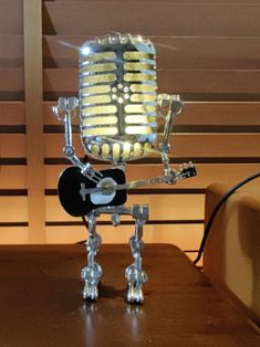 a microphone that is sitting on top of a table with a guitar in it's legs