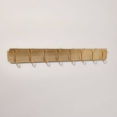 a wall mounted coat rack with five hooks