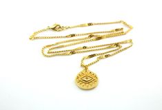 A rich golden eye has been crafted on a medallion and set on sturdy twinkling golden chains to create this gorgeous enchanting necklace, perfectly suited for layering. This open eye symbol is found across many cultures, bringing the bearer luck and protection. The 15x16mm 24k gold plated eye charm rests on 1.5x2mm 24k gold plated curb chains that have been flattened at even intervals to create a wavy starburst effect. This necklace is finished with a 24k gold plated lobster claw clasp. This neck Gold Medallion Necklace With Evil Eye, Gold Chain Necklace With Evil Eye As Gift, Gold Chain Necklace With Evil Eye For Gift, Evil Necklace, Crescent Moon Necklace Gold, Luck Necklace, Eye Of Providence, Star And Moon Necklace, Good Luck Necklace