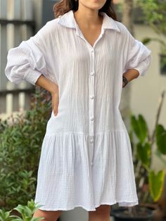 "This dress features a simple yet elegant collared neckline and long sleeves that add a touch of sophistication. Its versatile nature makes it perfect for a casual day out, a relaxing day at home, or even as a chic beach cover-up. The double-layered gauze fabric is gentle on the skin and gets softer with each wash, ensuring long-lasting comfort. Fits Small, Medium and Large Length - 35\" Sleeve Length - 24\" Bust - 44\" Model is 5′2″ (158cm) tall with a 81cm/32″ bust, 69cm/27″ waist, 92cm/36″ hips Important Notice Regarding Product Color Variations We strive to provide the most accurate and high-quality images of our products to enable you to shop with confidence. However, we would like to remind you that despite our best efforts, there may be slight variations in color between the images Solid Color Collared Shirt Dress For Beach, Collared Solid Shirt Dress For The Beach, Summer Long Sleeve Shirt Dress For Daywear, Knee-length Long Sleeve Summer Dress, Elegant Solid Shirt Dress For Beach, Summer Long Sleeve Shirt Dress With Relaxed Fit, Summer Long Sleeve Relaxed Fit Shirt Dress, Elegant Solid Color Shirt Dress For Beach, Relaxed Fit Long Sleeve Summer Shirt Dress