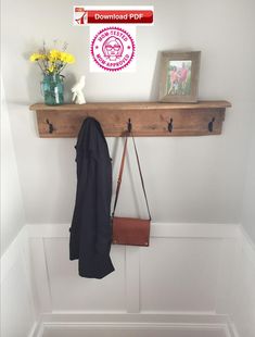 a coat rack with two coats hanging from it's hooks and a purse on the wall