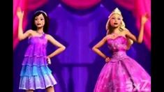 two barbie dolls standing next to each other in front of a stage with pink curtains