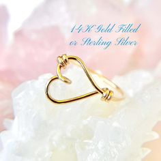 This sideways heart ring features an open heart design in 14K gold filled or sterling silver, perfect for any occasion. A thoughtful Mother's Day present, this custom heart outline ring makes a beautiful gift for women who love elegant, minimalist jewelry. ✦100% Handcrafted ✦ High quality 14K gold filled, 14K rose gold filled or sterling silver argentium ✦ Ring arrives in either a pink microfiber suede envelope/pouch or a blue/green drawer cardboard box as seen in the last image of this listing. ✦ Ready to ship in one business day ✦ Average shipping time (US/Canada/UK) three to five business days ✦ Tracking Available ✦Band  Width--1mm Color--gold, rose gold or silver Shape--round Texture--smooth Material--14K gold-filled, 14K rose gold-filled or sterling silver argentium wire Gauge--20 ✦US Green Drawer, Envelope Pouch, Mothers Day Present, Wire Gauge, Heart Outline, Mothers Day Presents, Open Heart, Romantic Gift, Dainty Ring