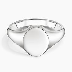 a white gold signet ring with an oval design on the front and center side