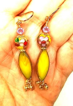 Cloisonne Earrings, Gold Hoop Earrings, Dainty Huggie Earrings, Minimalist Earrings, Dangle and Drop Earrings, Gift for Her  Beautiful Vintage Cloisonne beads decorate this round bead beautifully to add a very romantic look with purple, yellow and green surrounding the Cloisonne beads. Underneath is a beautiful pinkish flower to blend in with the Amethyst bicone crystal above.  I've added all 14K Gold Fill components:  Ball Tip Ear wires, spacers, and 3 tiny gold fill balls at the end.  At the t Whimsical Czech Glass Jewelry With Ear Wire, Whimsical Czech Glass Jewelry Set With Earrings, Party Yellow Pierced Jewelry, Whimsical Beaded Dangle Jewelry, Whimsical Czech Glass Drop Earrings, Teardrop Beaded Earrings For Gift, Pierced Czech Glass Drop Earrings, Pierced Teardrop Beaded Earrings For Gift, Pierced Teardrop Beaded Earrings As Gift