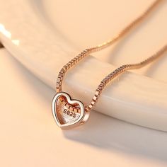 This product is a simple and elegant necklace made of silver It features a beautiful heart-shaped pendant. The necklace is designed for women and has a sleek electroplated finish. Its minimalist style makes it a perfect accessory for any outfit or occasion. Romantic Jewellery, Elegant Necklace, Elegant Necklaces, Beautiful Heart, Minimalist Necklace, Rose Gold Necklace, Love Necklace, Rose Gold Color, American Express