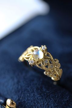 Sonia Moonstone Floral Gold Lace Filigree 18K Gold Vermeil Ring features moonstone in the centre, accented by lace filigree on the sides. It is similar to Monique Moonstone Ring in our shop, but the details of the ring are different. This is an adjustable ring, it comes in one size only and fits US ring size 5 to 8. ◊ 18K Gold Vermeil ◊ Adjustable Ring ◊ Sold in ONE SIZE only ◊ Fits US ring size 5 to 8 ◊ Lab Moonstone and cubic zircons ◊ Delivered in our signature royal blue box, it makes the pe 14k Gold Moonstone Open Ring, Gold Moonstone Promise Ring In 14k Gold, Gold 14k Moonstone Promise Ring, Gold Opal Open Ring For Promise, Heirloom Gold Moonstone Jewelry, Gold Moonstone Jewelry With Rose Cut Diamonds, Gold Moonstone Ring With Gemstone Accents For Anniversary, 14k Gold Moonstone Ring With Gemstone Accents, Dainty Gold Moonstone Ring For Anniversary