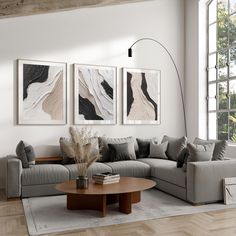 a living room with three paintings on the wall