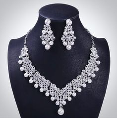 A beautiful three-piece bridal jewelry set for the romantic bride! Adorned with iridescent pearls and intricately faceted rhinestone crystals that capture the light from every angle with a perfectly translucent appeal, the pieces are rhodium plated for a flawless finish which enhances the intricate detailing and conveys a modern take on old elegance. Necklace: Length: 18" with a 2" extension chain for comfortable sizing (if you would like it longer, please include a message at the time of order Silver Pearl Bridal Sets For Formal Occasions, Formal Silver Pearl Bridal Sets, Elegant Pearl Bridal Sets With Pearl Drop, Crystal Pearl Necklace With Rhinestones For Wedding, Elegant Silver Pearl Jewelry Sets, Elegant Pearl Bridal Sets For Weddings, Silver Pearl Bridal Accessories For Bride, White Rhinestone Bridal Jewelry, Crystal Pearl Drop Jewelry Sets For Wedding