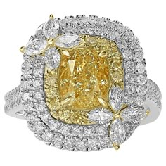 This stunning piece is a true testament to unparalleled craftsmanship and sophisticated design, destined to capture hearts and turn heads. At the center of this magnificent ring lies a breathtaking 2.00 carat Natural Yellow Diamond. This radiant gem, known for its vibrant hue and dazzling brilliance, serves as a symbol of rarity and luxury, ensuring that its wearer stands out in any crowd. Encircling this captivating center stone is a mesmerizing triple halo, meticulously crafted from an array o Gia Certified Marquise Diamond Ring, Gia Certified Marquise Diamond Ring Fine Jewelry, Yellow Platinum Diamond Wedding Ring, Luxury Gia Certified Cluster Ring In Yellow Gold, Luxury Gia Certified Yellow Gold Cluster Ring, Gia Certified Marquise Diamond Ring For Anniversary, Gia Certified Marquise Cut Luxury Diamond Ring, Luxury Marquise Cut Gia Certified Diamond Ring, Gia Certified Luxury Marquise Cut Diamond Ring