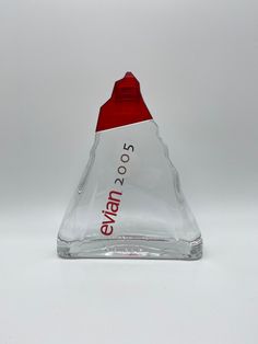 a red and white triangle shaped bottle with the word evan on it's side