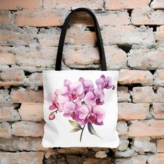 "This Beautiful Watercolor Orchid Tote Bag will make a perfect gift for yourself or any flower lover you know. The vibrant watercolor colors of the flowers make this bag match any outfit for everyday use. Perfect for all ages. It is made from durable lasting materials. - Made with 100% polyester, a medium-weight fabric that is Extremely strong, highly durable, and perfect for everyday use. - All tote bags come with a non-woven laminate inside - Black cotton handles - reinforced second row of sti Pink Flower-shaped Shoulder Bag As A Gift, Floral Bags For Mother's Day Gift, Pink Flower-shaped Shoulder Bag For Gifts, Pink Flower-shaped Shoulder Bag As Gift, Flower Shaped Bags For Mother's Day Gift, Flower-shaped Bags For Mother's Day Gift, Mother's Day Gift Floral Print Bag, Mother's Day Floral Print Gift Bag, Purple Floral Print Bag For Everyday Use