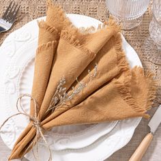 the napkins have been folded on top of each other and tied together with twine