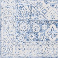 a blue and white rug with an intricate design