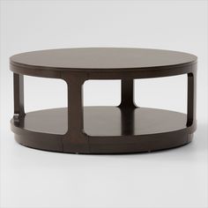 a round coffee table with two shelves on each side