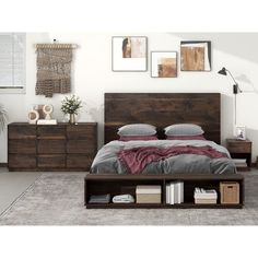 a bed sitting in a bedroom next to a dresser with drawers on each side and pictures above it