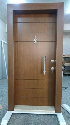 a wooden door with metal handles and knobs on the front entrance to an office building