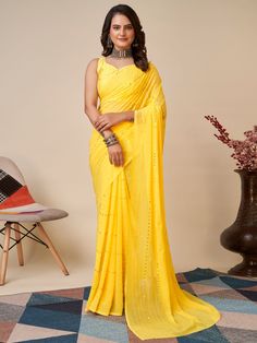 Elevate your wardrobe with our charming yellow sequins georgette haldi wear saree with blouse. This stunning saree is crafted with high-quality georgette material, featuring delicate thread embroidery and sequin work that adds a touch of elegance to the overall look. The vibrant yellow color of the saree is perfect for any festive occasion, especially haldi ceremonies.
The georgette fabric ensures a comfortable and flowy drape, making it easy to move and dance in. The matching art silk blouse co Yellow Georgette Pre-draped Saree With Pallu, Yellow Chikankari Embroidered Fitted Pre-draped Saree, Yellow Fitted Pre-draped Saree With Chikankari Embroidery, Fitted Yellow Pre-draped Saree With Chikankari Embroidery, Yellow Chinon Pre-draped Saree, Fitted Yellow Pre-draped Saree With Mirror Work, Yellow Fitted Saree With Mirror Work, Fitted Yellow Saree With Mirror Work, Yellow Saree With Mirror Work For Festivals