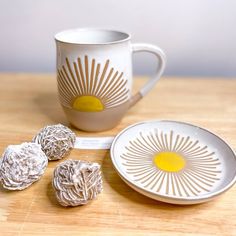 three pieces of chocolate sitting on top of a wooden table next to a cup and saucer