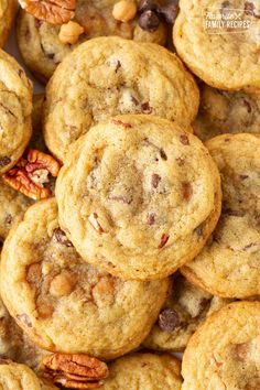 a pile of cookies with pecans and nuts on top