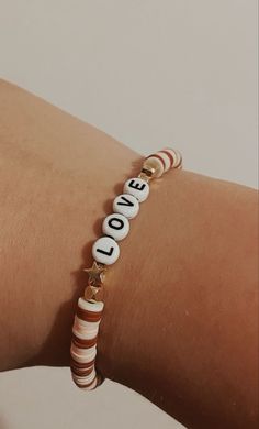 a woman's arm with a bracelet that says love on the front and back