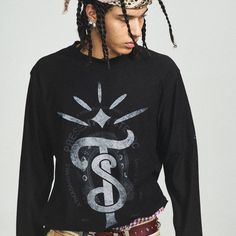 The Totem Ripped Edge Long-Sleeve Tee brings together vintage style and intricate craftsmanship for a standout look. Featuring a striking totem graphic on the front alongside a subtle logo print, this tee captures attention with its bold design. The distressed, frayed detailing on the collar and cuffs adds a rugged touch, enhancing the worn-in feel of the piece. Crafted from premium 100% cotton, the slightly oversized fit offers both comfort and laid-back style. Totem graphic and logo print on f Vintage Print Crew Neck Tops For Streetwear, Vintage Long Sleeve Tops With Graphic Design, Vintage Long Sleeve Graphic Tops, Black Tops With Vintage Print For Streetwear, Distressed Long Sleeve, Half Shirts, Hoodie Set, Jean Accessories, Tops Fall