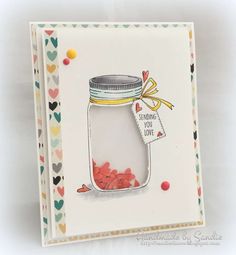 a handmade card with a jar of candy on the front and a tag that says sending love