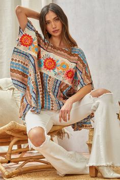 Floral Poncho Top This Woven Poncho Top features delicate floral embroidery across the front. The neckline is round and the fit is flowy and loose, making it a comfortable and stylish choice. A S/M fits a bust of 34-36" (a size 4-8) and a M/L fits a bust of 35-38" (a size 6-10). Brand: Savanna Jane Poncho Top, Painted Hats, Silver Chain For Men, Buckles Fashion, Wild Rag, Poncho Tops, Kids Outerwear, Top Graphic Tees, Chains For Men