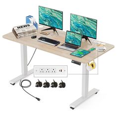 two computer monitors sitting next to each other on a desk with power cords and plugs