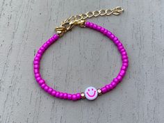 This bright and hot pink smiles bracelet will be sure to make you...well...smile! Brighten your day or any outfit with this fun accessory. Fun Pink Jewelry With Letter Beads, Pink Adjustable Friendship Bracelet, Adjustable Pink Beaded Bracelets With Letter Beads, Casual Pink Friendship Bracelets With Colorful Beads, Trendy Pink Beaded Bracelets With Letter Beads, Trendy Pink Adjustable Bracelet, Trendy Pink Bracelet With Adjustable Length, Trendy Pink Adjustable-length Bracelet, Pink Fun Bracelets With Round Beads