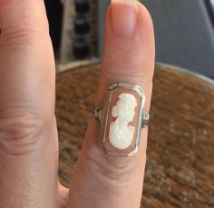 "Antique Edwardian 14k White Gold Filigree Carved Conch Cameo Ring Size 3.75 The item up for offer is a lovely antique Edwardian solid 14k white gold filigree hand carved conch shell cameo ring. The cameo features the bust of a lady and is well defined in its features. This ring is marked \"14k\". Measurements Ring Size: 3.75 (Small! Ask Us About Resizing!) Band Width: 1.6mm Ring Face: 21mm x 12mm Weight: 3.5 g Condition: Excellent; item is pre-owned and may have some signs of light use. Please Antique Engraved Wedding Ring, White Oval Carved Ring, White Oval Carved Rings, Antique White Collectible Jewelry, Antique Collectible White Jewelry, Collectible 14k Gold White Jewelry, Collectible White 14k Gold Jewelry, Heirloom Style White Sterling Silver Engraved Ring, Heirloom Style Engraved White Sterling Silver Ring